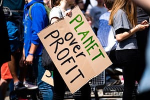 A sign saying "Planet Over Profit"