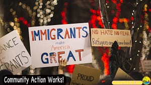 A protest march, someone with a sign saying "Immigrants Make America Great." At bottom left of photo are the words, "Community Action Works!"